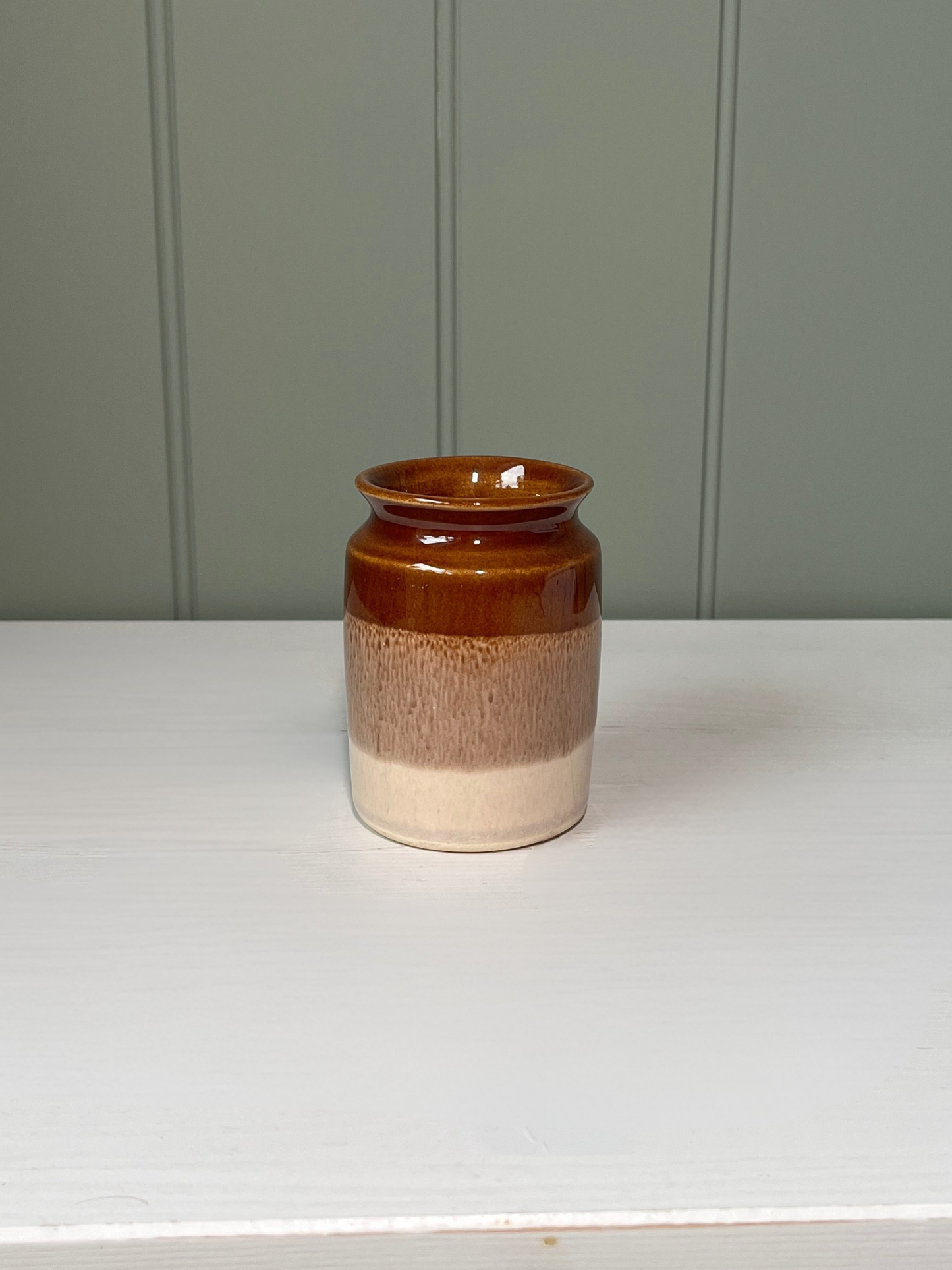 Handmade vintage pottery jug or vase with dipped cream and brown finish