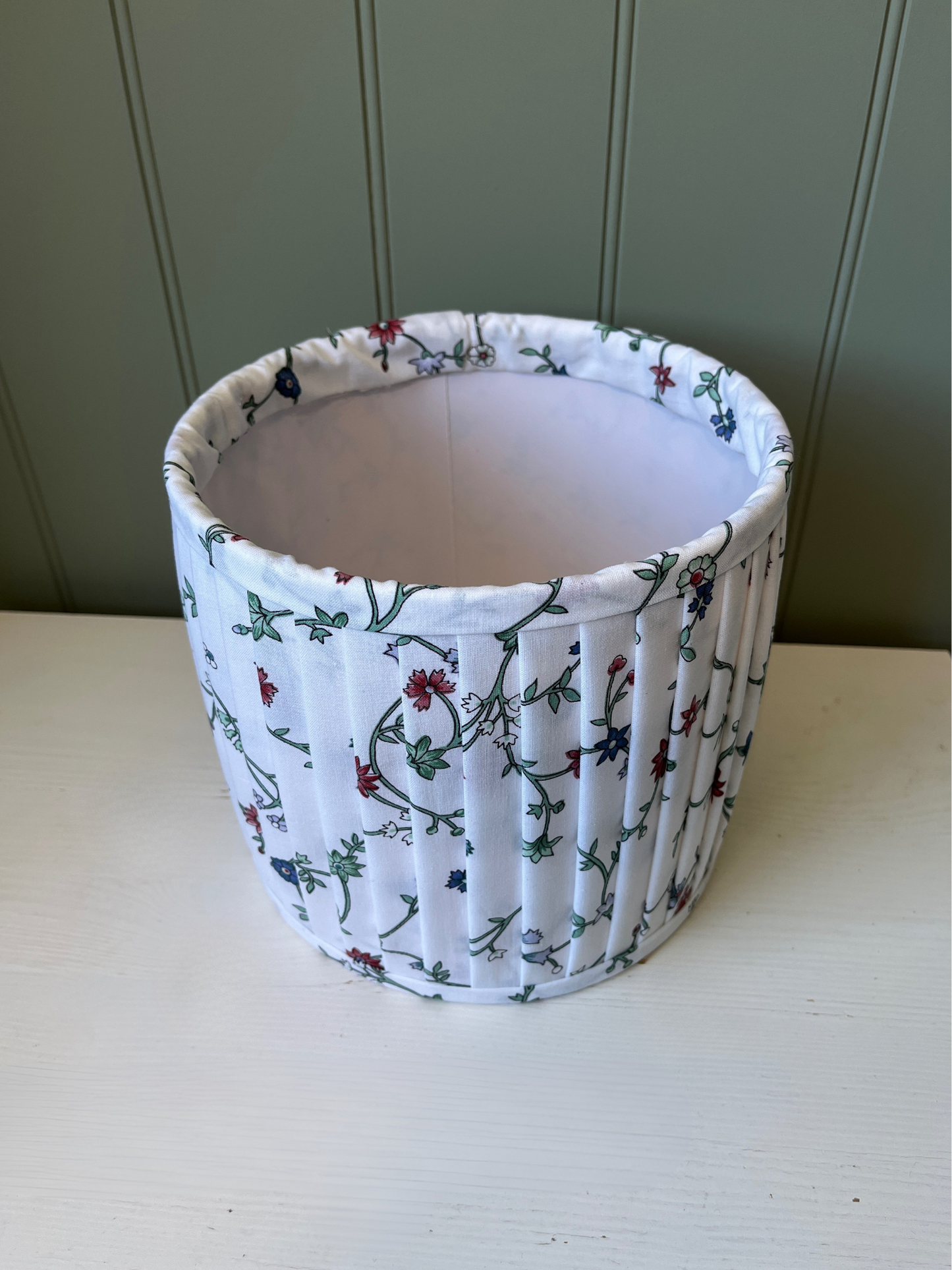Pleated lampshade with white, red and blue floral fabric