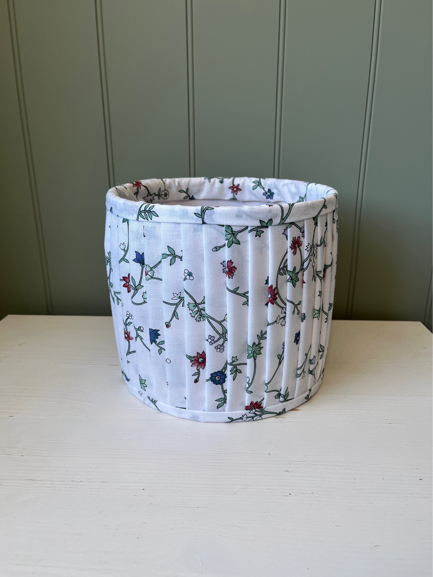 Pleated lampshade with white, red and blue floral fabric